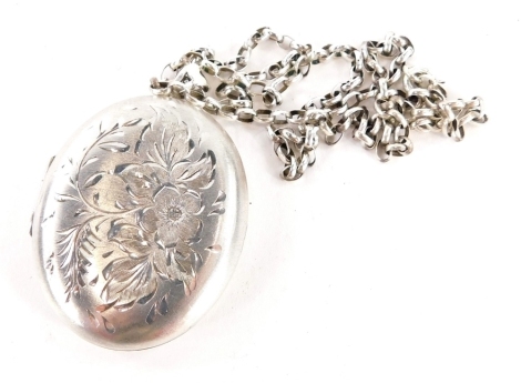 A silver oval locket pendant and chain, the locket with engraved floral design, 4.5cm high, on a silver belcher chain, 50cm long, 27.9g.