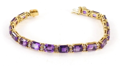 An amethyst and diamond set bracelet, with rectangular cut amethyst stones, broken by arrangement of diamonds, each in claw setting, on a yellow metal band, stamped K18, 19cm long, in AB Davis of Mayfair box, 28.4g all in.