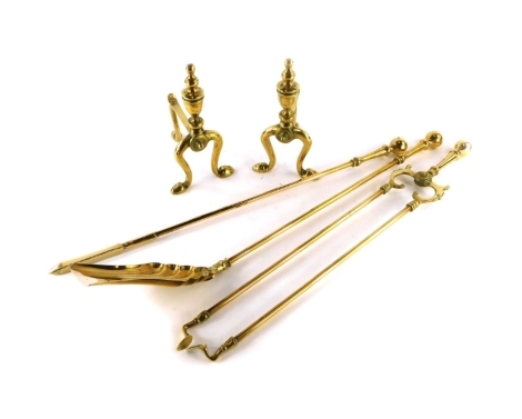 A group of brass fire implements, to include a set of three irons and two trivets (5)