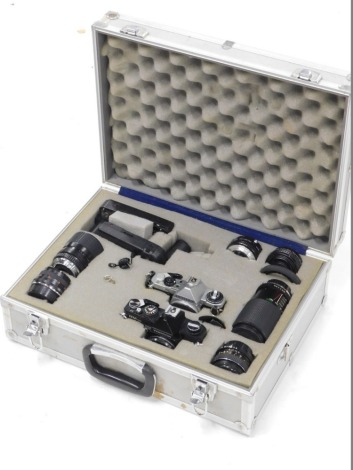 An aluminium camera carrying case, with two cameras and various lenses, to include a Topcon RM300, and a Pentax ME Super, together with a Hoya HMC 35-75mm lens, A Hoya Top Man MC1-2.8, two flashes, a Prinzflex converter, a Vivitar converter 2x22, a Vivita