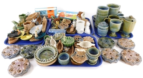 A quantity of Wade Whimsies and other items, to include some Irish Wade pieces, ashtrays with dogs, pixies, birds, fish, etc., two Wade pipe stands, figurines, Viking ship, etc. (4 trays plus)