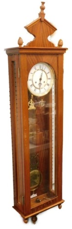 A Vienna wall clock, in a mahogany veneered case with enamel type dial, 128cm high overall.