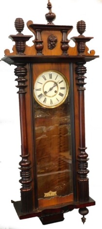 A late 19th/early 20thC Vienna wall clock, in a walnut case with enamel type dial, 119cm high.