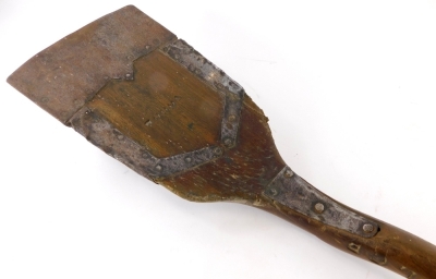 A turned wooden and iron malt type shovel, with metal mounts, stamped to side W OOS, 120cm long.