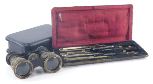 A cased geometry set, an early 20thC box of oblong form and a pair of opera binoculars. (3)