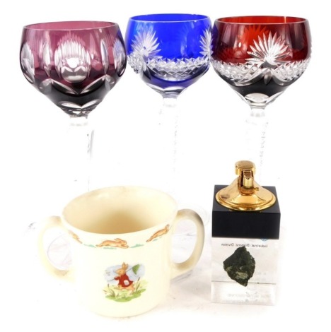 Three continental wine glasses, each with coloured bowls, a De Beers rough diamond promotional lighter, and a Bunnykins loving cup.