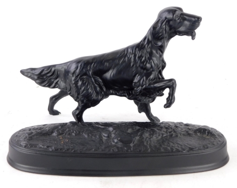 A black glazed Beswick figure of a setter, on oval base, 29cm wide. (AF)