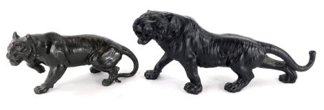 An oriental style black spelter figure of a tiger, 34cm long, and another similar, 23cm long. (2)