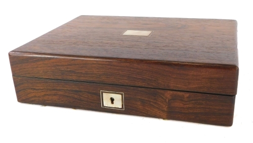 A Victorian rosewood writing box, the top with a vacant rectangular mother of pearl cartouche enclosing a fitted interior with later slope and fitted tray, etc., 27cm wide.