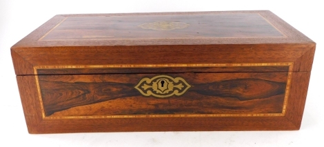 A rosewood and mahogany writing box, the top inlaid with a brass cartouche enclosing a fitted interior, Victorian and later, 50cm wide.