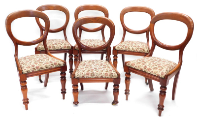 A set of six Victorian mahogany balloon back chairs, each with a drop in seat on turned legs, one reduced in height, others lacking castors, etc.