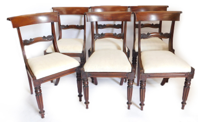 A set of six William IV mahogany dining chairs, each with a shaped bar back and reeded uprights, a drop in seat on turned and fluted legs.