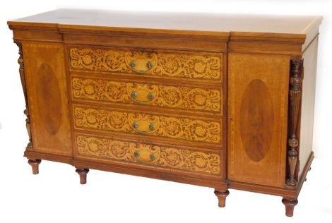 A late 19th/early 20thC continental and marquetry breakfront sideboard, the top with a rosewood crossbanded border above three drawers, each profusely inlaid with scrolls, flowers, etc., and with brass drop handles flanked by two doors and two turned and 