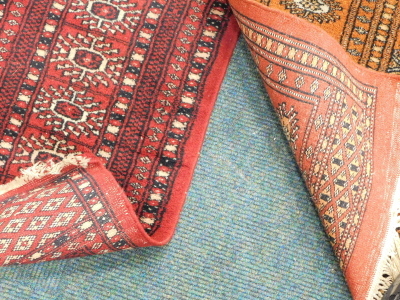 Two Afghan Belouch rugs, each with a design of medallions on a red ground. - 3