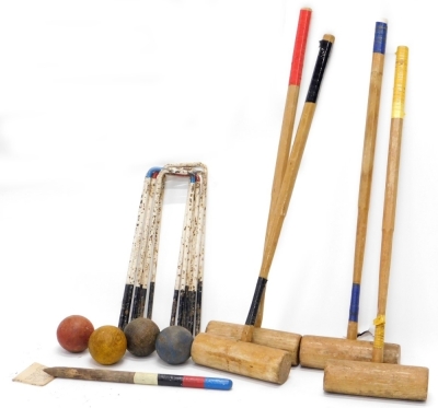 A croquet set, with four mallets, various hoops and four balls.