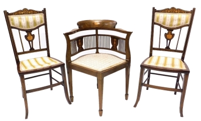 A suite of three chairs, each decorated with marquetry and simulated stringing, comprising a corner chair and two bedroom chairs, of differing upholstery.