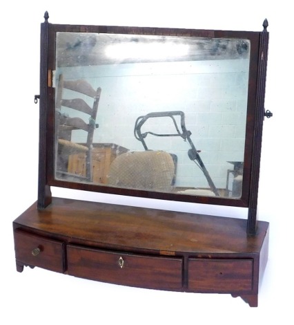 A 19thC mahogany dressing table mirror, with a rectangular plate and reeded supports, on bow fronted base, with three drawers and bracket feet.