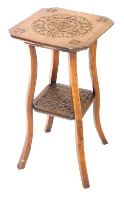 An early 20thC carved hardwood two tier table, on shaped supports, 34cm wide.