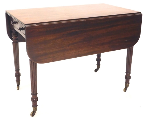 A William IV mahogany Pembroke table, the rectangular top with rounded corners and a channelled edge, above a frieze drawer, flanked by brass inlaid patera, on turned reeded legs with brass castors, 72cm high,98cm wide, the top 112cm x 98cm overall.