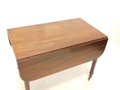 A William IV mahogany Pembroke table, the rectangular top with rounded corners and a channelled edge, above a frieze drawer, flanked by brass inlaid patera, on turned reeded legs with brass castors, 72cm high,98cm wide, the top 112cm x 98cm overall. - 2