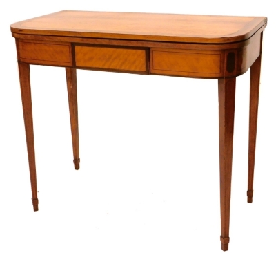 A George III satinwood and burr wood D shaped tea table, the flat panelled frieze with a central drawer, on square tapering legs with splayed feet, 75cm high, 86cm wide, 45cm deep.