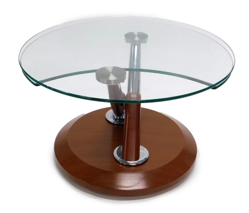 A modern glass topped coffee table, with chrome plated supports and hardwood base, 69cm diameter.
