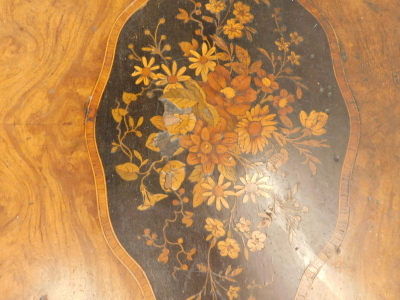 A 19thC walnut library table in French style, the shaped rectangular top with a central marquetry cartouche of flowers on an ebony ground, within tulipwood crossbanded borders, above two frieze drawers on crossbanded cabriole legs, 71cm high, 105cm wide, - 2