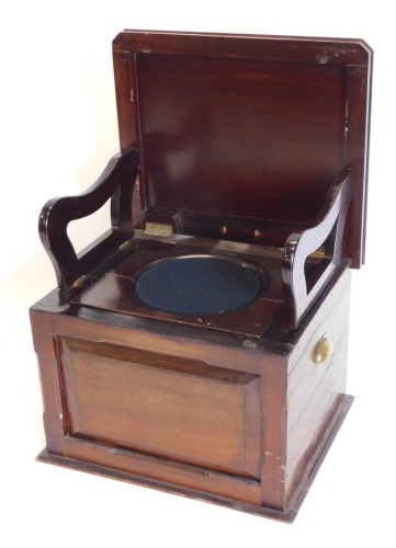 A Victorian walnut box commode, the hinged lid enclosing hinged arm rests, a recess, etc., above a panel front with brass side handles, 52cm wide.