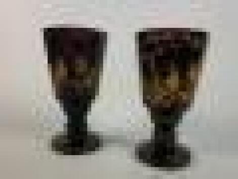 A pair of late 19thC Bohemian purple glass facetted goblets