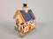 An early 19thC pottery savings bank in the form of a cottage with figures