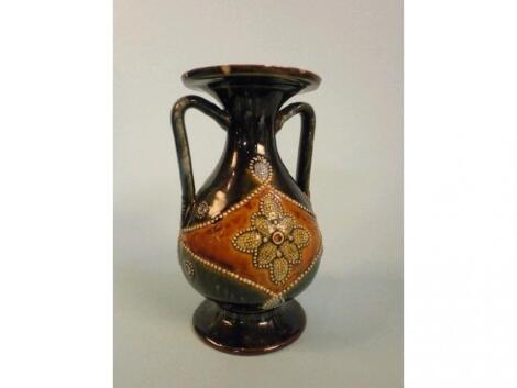 A Royal Doulton stoneware two-handled vase decorated with flowers within