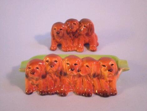 Beswick. Three puppies and five puppy ashtray