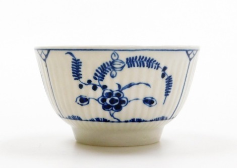 A Worcester tea bowl, on white finish with blue floral detailing, C stamp to underside, 8cm diameter.