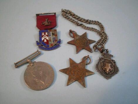 A 1939-45 Star, a 1939-45 Defence medal, a Burma star medal, a silver fob