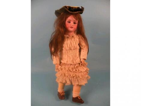 A Simon & Halbig bisque headed doll numbered to back of head 11.5 with a papier mache body