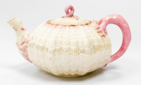 A Belleek black mark first period Tridacna teapot and cover, c1880, with pink border and gilt line, 13cm diameter.