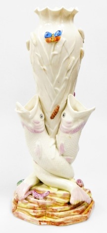 A large Belleek black mark triple fish vase, the vase supported by three open mouth fish on a rocky base, the vase has applied coloured butter files, caterpillars and lizards, 40cm high. (AF)