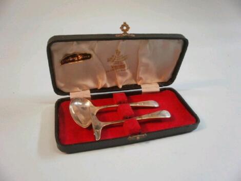 A silver baby pusher and spoon