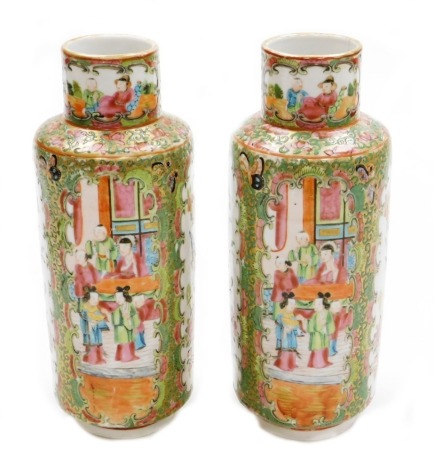 A pair of Chinese Canton vases, each with panels of figures, birds and flowers on a gilt and green flowered ground, 19thC, 26cm high.