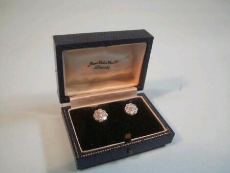 A pair of diamond cluster earrings