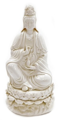 A Chinese blanc de chine figure of Guan Yin seated on a lotus and wave base, impressed mark to the rear, 46cm high. (AF)