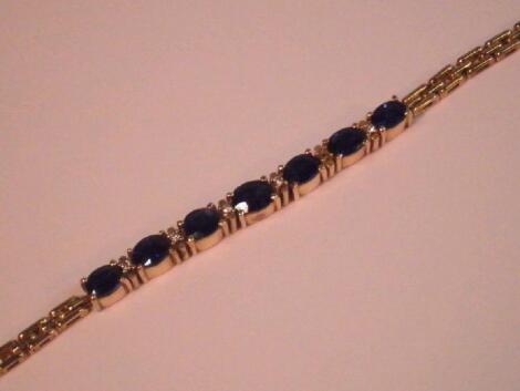 A sapphire and diamond bracelet set in yellow metal