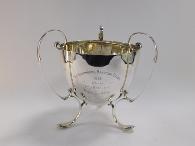 A George V silver trophy, presentation engraved The Huntingdon Handicap Chase 1929, Won By Mr J Mackley's 'Waverley Star', with triple scroll handles, raised on conjoined scroll feet, Walker & Hall, Sheffield 1928, 50.8oz, 27cm high. - 2