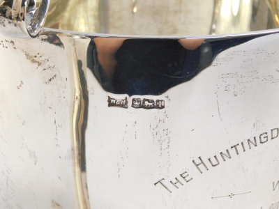 A George V silver trophy, presentation engraved The Huntingdon Handicap Chase 1929, Won By Mr J Mackley's 'Waverley Star', with triple scroll handles, raised on conjoined scroll feet, Walker & Hall, Sheffield 1928, 50.8oz, 27cm high. - 5