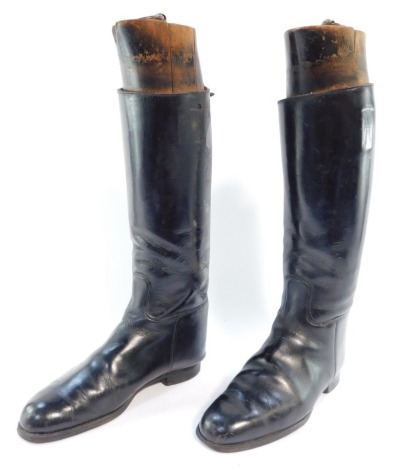 A pair of black leather riding boots, with wooden stays.