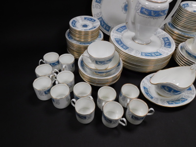 A Coalport porcelain dinner tea and coffee service decorated in the Revelry pattern, comprising oval meat platter, sauce boat on stand, twelve dinner and eleven dessert plates, twelve fruit bowls, coffee pot, cream jug, two sugar bowls, a pair of bread pl - 3