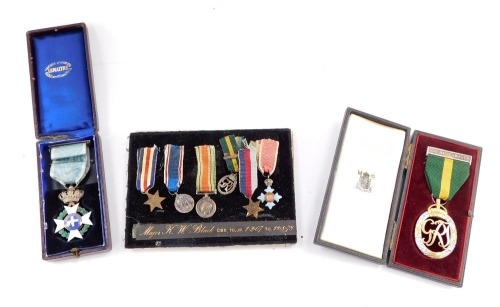 A group of miniature medals, named to Major K W Bland, CBE., TD., JP., Lived 1.2.07 to 11.08.78., comprising France and Germany Star, 1939-1945 Star, and Defence Medal, CBE, Territorial George V Efficiency Medal, and a George VI Coronation Medal, framed a