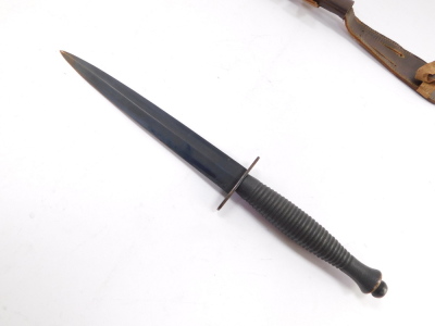 A Fairbairn Sykes Commando knife, with a foiled grip, leather sheath, 31cm high. - 2