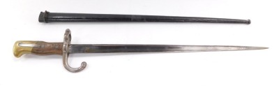 A St Etienne bayonet, with engraved blade dated 1877, with scabbard, 65.5cm wide.