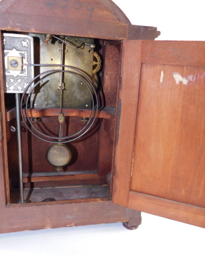 A late Victorian mahogany and inlaid mantel clock, circular enamel dial bearing Arabic numerals, German eight day movement, with coil strike, the case of domed architectural form, with brass capped columns, raised on a plinth base, on bun feet, with pendu - 4